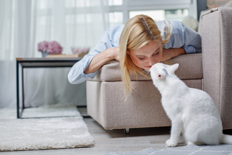 Woman cuddling with her indoor cat