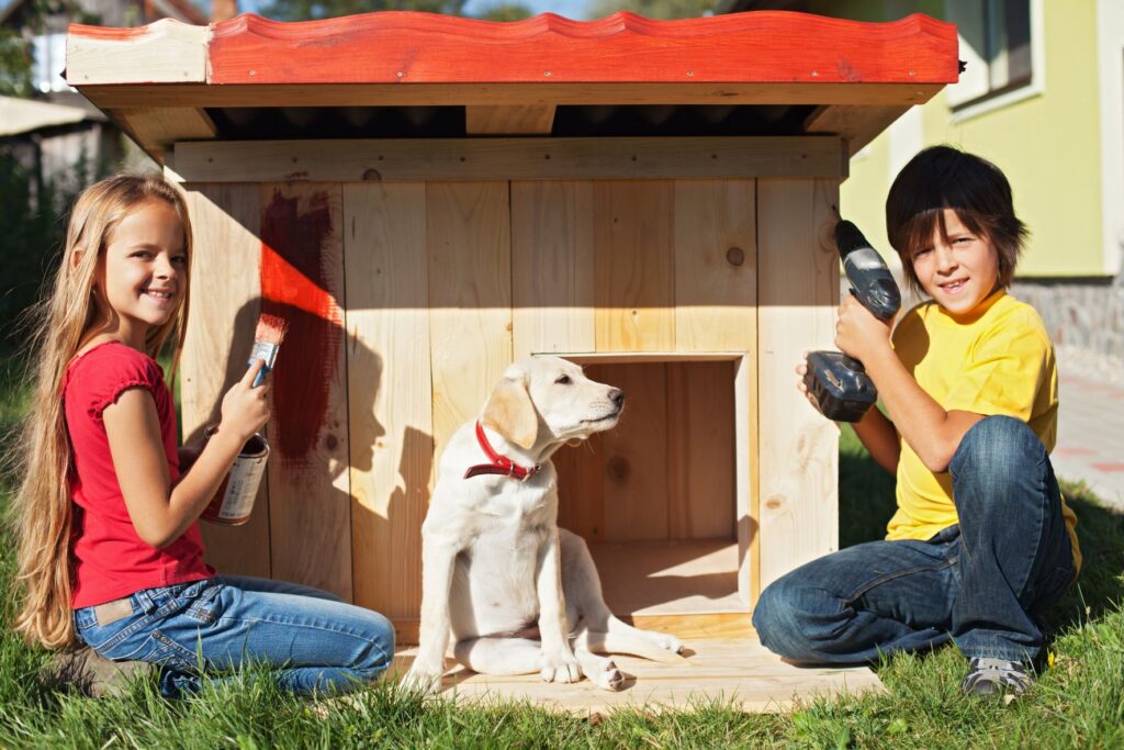 Children helping to build a dog kennel Children helping to build a dog kennel