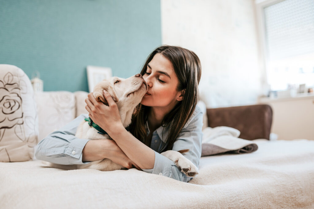 Woman kissing dog